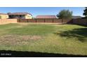 Large grassy backyard enclosed by a block fence, perfect for outdoor activities and relaxation at 259 E Montego Dr, Casa Grande, AZ 85122