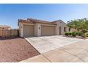 Charming single-story home with a three car garage, desert landscaping, and a tile roof at 259 E Montego Dr, Casa Grande, AZ 85122
