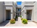 Close-up of townhouses featuring private entrances and well-manicured landscaping for a welcoming feel at 295 N Rural Rd # 160, Chandler, AZ 85226