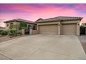 Charming single-story home featuring a three-car garage and low-maintenance desert landscaping at 32020 N 20Th Dr, Phoenix, AZ 85085