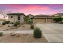 Charming single-story home featuring a three-car garage and low-maintenance desert landscaping at 32020 N 20Th Dr, Phoenix, AZ 85085
