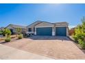 Well-maintained house with a three-car garage and desert landscaping in a sunny neighborhood at 32729 N Mach Ln, San Tan Valley, AZ 85143