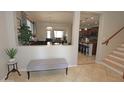 Open concept view of the living and dining room with stairs and neutral tile floors at 3581 S Arizona Pl, Chandler, AZ 85286