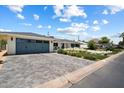 Wide driveway leading to a charming home with a two-car garage and a well-maintained lawn at 4010 E Coolidge St, Phoenix, AZ 85018