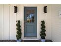 Stylish front door with decorative plants adding a touch of elegance to the home's entrance at 4010 E Coolidge St, Phoenix, AZ 85018