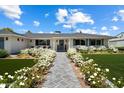 Inviting home with a beautifully landscaped front yard featuring vibrant green grass and elegant white flowers at 4010 E Coolidge St, Phoenix, AZ 85018