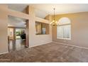 The dining area boasts neutral colors and plush carpet, creating a cozy atmosphere at 4223 E Danbury Rd, Phoenix, AZ 85032