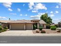 Inviting home featuring a three-car garage and mature landscaping at 4223 E Danbury Rd, Phoenix, AZ 85032