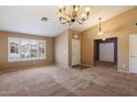 A spacious living area features large windows, carpet floors and neutral paint at 4223 E Danbury Rd, Phoenix, AZ 85032