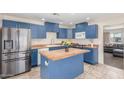 Modern kitchen featuring bold blue cabinets, stainless steel appliances and butcher block countertops and island at 4238 W Krall St, Phoenix, AZ 85019