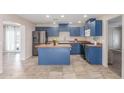 A bright kitchen offers blue cabinets, stainless steel appliances, butcher block countertops, and tile flooring at 4238 W Krall St, Phoenix, AZ 85019