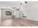 Spacious living area with archway and backyard views, offering versatile space for work or relaxation at 44853 W Jack Rabbit Trl, Maricopa, AZ 85139