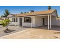 Cozy house with a large carport, low-maintenance yard, and white brick exterior at 4526 W Mission Ln, Glendale, AZ 85302