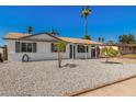 Inviting single-Gathering home featuring a low-maintenance gravel yard and covered carport at 4526 W Mission Ln, Glendale, AZ 85302