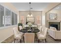 Elegant dining room with a marble table, seating for six, and stylish decor at 4528 E Donato Dr, Gilbert, AZ 85298