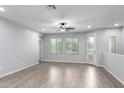 Bright living room featuring wood-look floors, a ceiling fan, and plenty of natural light at 5550 N 16Th St # 166, Phoenix, AZ 85016