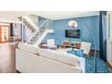 Bright living room with modern decor, open staircase, and stylish furnishings at 6945 E Osborn Rd # B, Scottsdale, AZ 85251