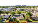 Aerial view of a neighborhood with well-manicured lawns, palm trees, and mountain views at 743 W Ocotillo Rd, Phoenix, AZ 85013