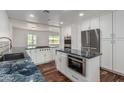 Bright kitchen with white cabinetry, stainless steel appliances, blue granite countertops, and an open design at 8315 E Vernon Ave, Scottsdale, AZ 85257