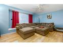 Comfortable living room with plush sectional sofa, ceiling fan, and natural light from a window at 8532 E Sheridan St, Scottsdale, AZ 85257