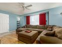 Bright living room with a large sectional sofa, a ceiling fan, and natural light from a window at 8532 E Sheridan St, Scottsdale, AZ 85257