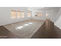 Open concept living space featuring lots of natural light and hardwood flooring at 9051 W Iona Way, Peoria, AZ 85383