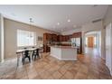 Open-concept kitchen and dining area featuring a breakfast bar and stainless steel appliances at 10465 E Knowles Ave, Mesa, AZ 85209
