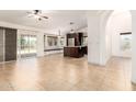 View of the combined dining and kitchen area with tile flooring and large windows at 1063 W Vaughn St, Tempe, AZ 85283