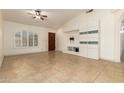 An open-concept room with tile flooring, an arched window, and a built-in media center at 1063 W Vaughn St, Tempe, AZ 85283