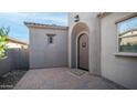 Front door view with brick pavers, welcome mat, and neutral stucco walls at 1123 W Thunderhill Dr, Phoenix, AZ 85045