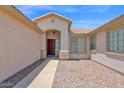 Inviting front entrance features a red door, tile roof, and desert landscaping at 11306 E Rembrandt Ave, Mesa, AZ 85212