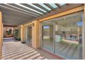 Covered outdoor patio with sliding glass doors that lead to the backyard swimming pool at 1131 N Cherry --, Mesa, AZ 85201