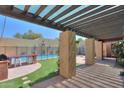 Covered outdoor patio with a built-in grill and a view of the sparkling swimming pool at 1131 N Cherry --, Mesa, AZ 85201