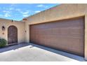 A large, two-car garage with an adjacent arched door in a charming single-story home at 1131 N Cherry --, Mesa, AZ 85201