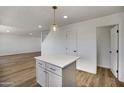 Bright kitchen features a white island with gray cabinets and pendant lighting at 1236 S Boulder St # C, Gilbert, AZ 85296