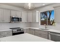 Bright kitchen features white cabinets, stainless steel appliances, and quartz countertops at 1236 S Boulder St # C, Gilbert, AZ 85296