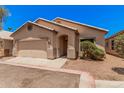 Inviting single-story home with a well-maintained front yard and two-car garage at 125 N 22Nd Pl # 128, Mesa, AZ 85213