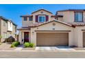Charming two-story home featuring a two-car garage, manicured lawn and beautiful brown trim at 1255 N Arizona Ave # 1013, Chandler, AZ 85225