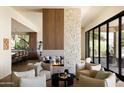 Open living room design with modern fireplace, comfortable seating, wood and stone accents, and abundant natural light at 12887 N 135 St, Scottsdale, AZ 85259