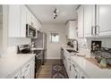 Bright kitchen with white cabinets, stainless steel appliances, and stylish countertops at 1352 W Naranja Ave, Mesa, AZ 85202