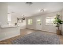 Open-concept living area featuring hardwood floors, neutral paint, and bright, natural light at 1352 W Naranja Ave, Mesa, AZ 85202