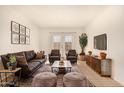 Comfortable living room featuring a leather sofa, two armchairs, stylish coffee table and decorative rug at 1439 N 53Rd Ave, Phoenix, AZ 85043