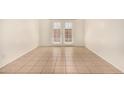 Empty room with tile flooring and french doors that provide natural light at 1439 N 53Rd Ave, Phoenix, AZ 85043