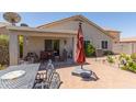 This backyard features brick pavers, a patio with comfortable seating, and a beautiful landscape at 1628 E Aspen Ave, Buckeye, AZ 85326