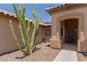 Welcoming front entry featuring desert landscaping and a covered entryway at 16288 W Hadley St, Goodyear, AZ 85338