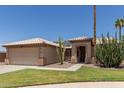 Inviting single-story home featuring well-maintained landscaping, tile roof, and a two-car garage at 16288 W Hadley St, Goodyear, AZ 85338