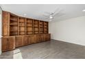 Spacious living room featuring custom built-in shelving and tile flooring at 1712 N Old Colony --, Mesa, AZ 85201