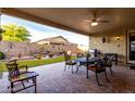 Covered patio features a stone water feature and outdoor dining set with wrought iron chairs at 17812 W Primrose W Ln, Surprise, AZ 85374