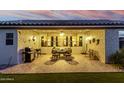 Covered patio with brick flooring, a ceiling fan, and outdoor seating for dining and relaxation at 17812 W Primrose W Ln, Surprise, AZ 85374