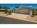 A well maintained house with desert landscaping and a large driveway at 215 N Power Rd # 21, Mesa, AZ 85205
